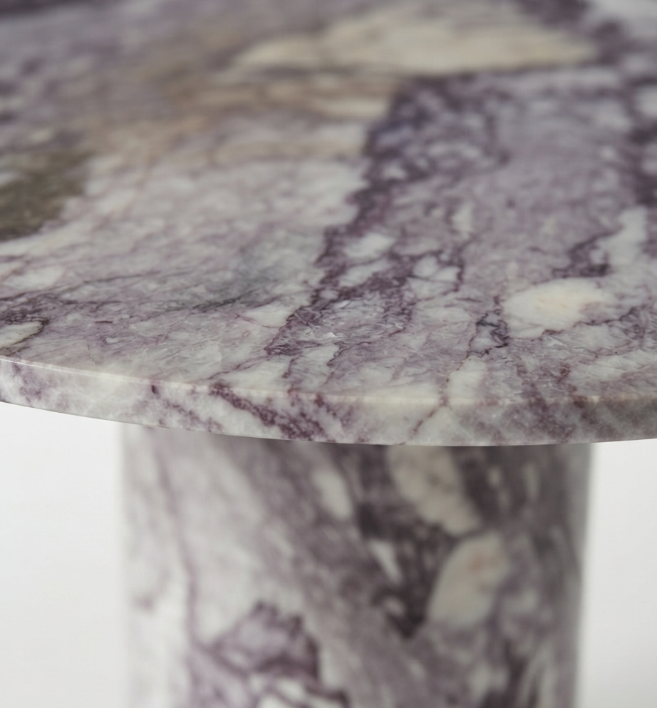 Close-up of the marble tabletop edge and pedestal join